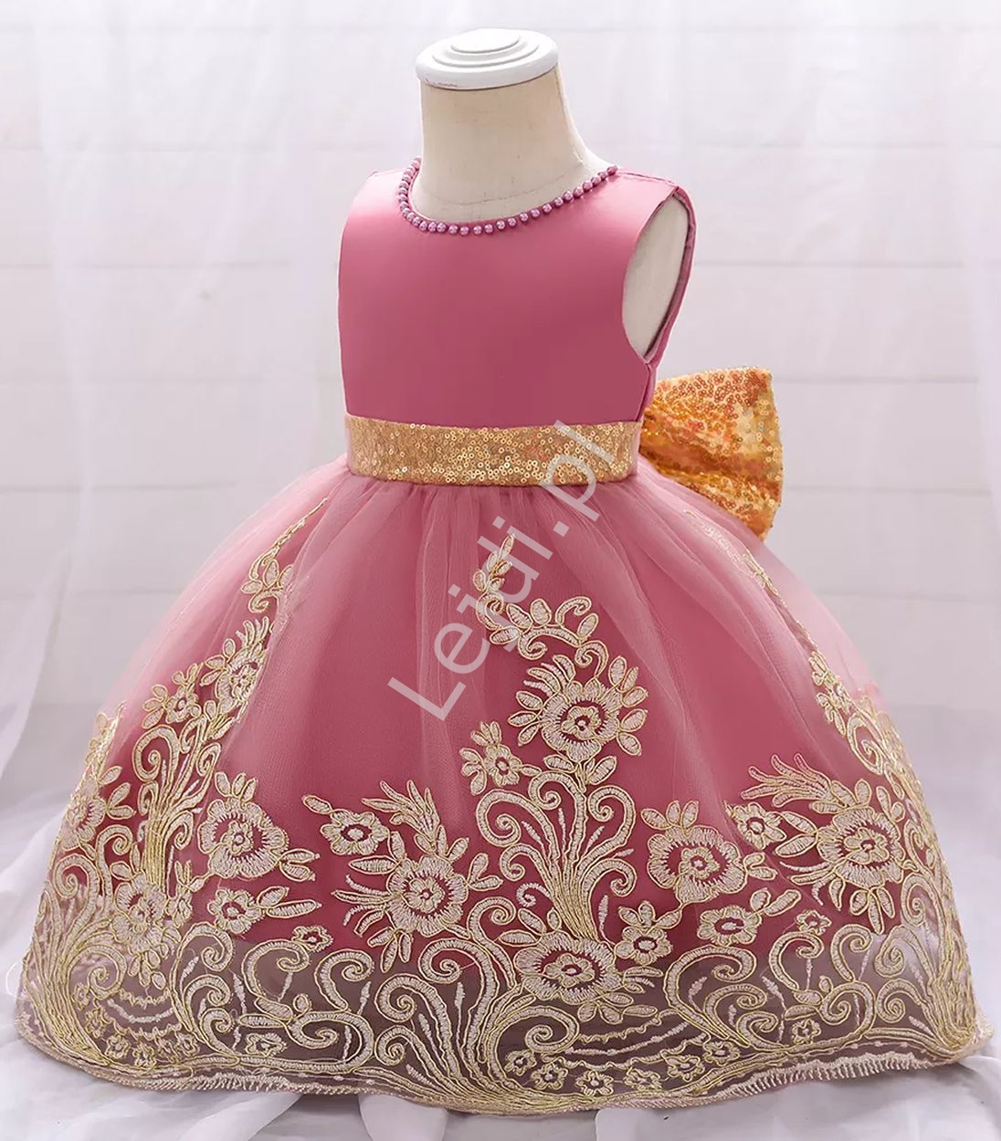 Fenomenalna sukienka dla dziewczynki w różowy kolorze złota kokardą